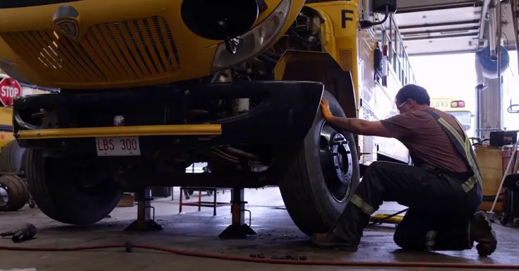 Person fixing schoolbus