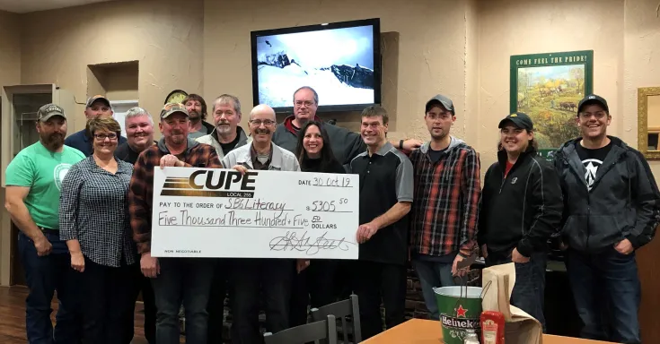 Image of group of people from CUPE 255 holding a giant cheque