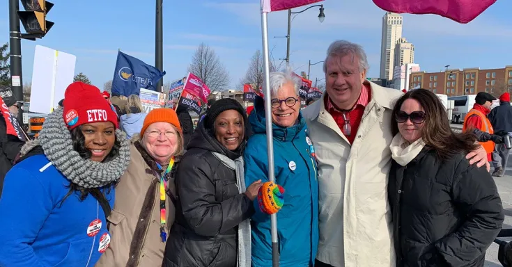 Group of CUPE Ontario activists standing together with flag