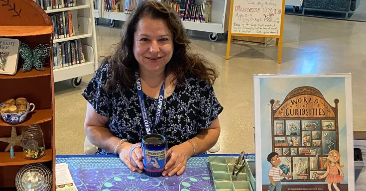Woman sitting at a table in a library 