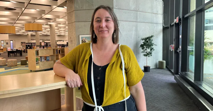 woman standing in a library 