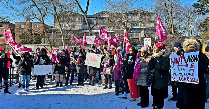 People holding flags and signs at a rally