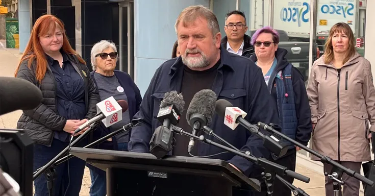 People standing at a podium for a press conference 