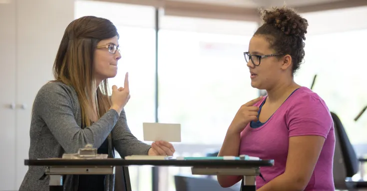 Female speech therapist helping a teenager