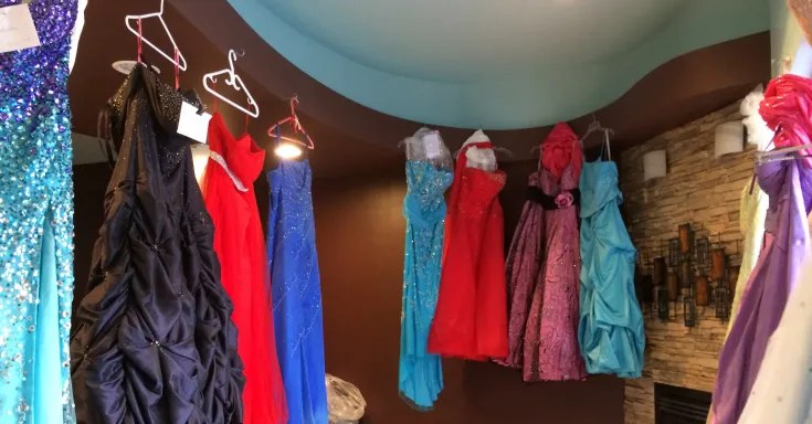 Multi-coloured formal dresses hanging in a row