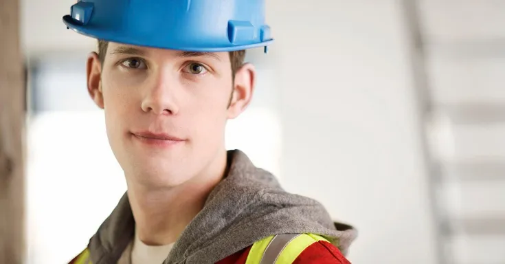 Young worker with safety hat and vest