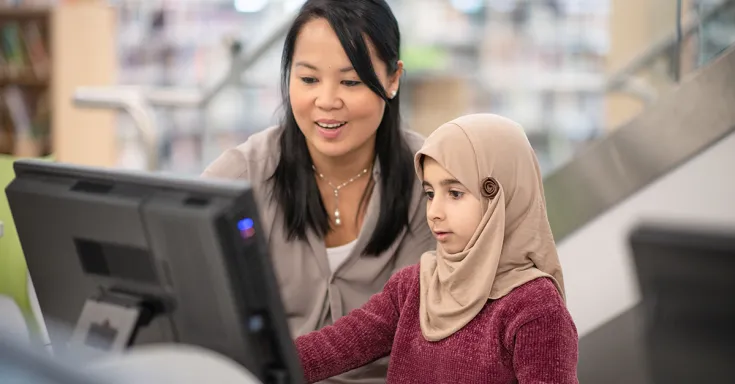 woman at computer with a child