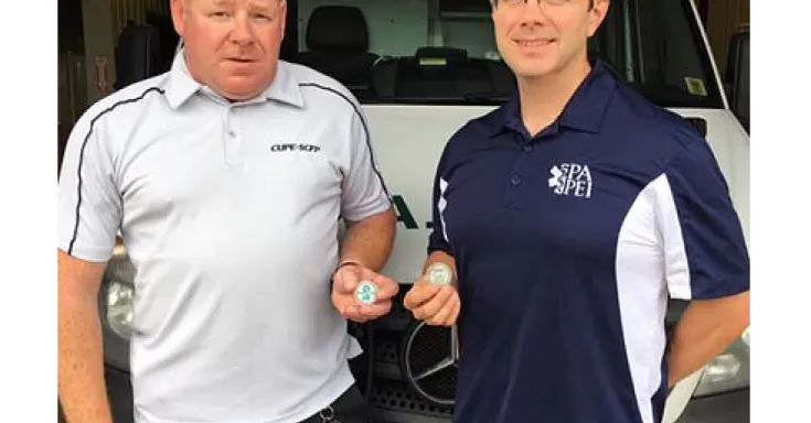 Commemorative coin; Jason Woodbury, President of CUPE 3324 and Ryan O’Meara, President of PAPEI.