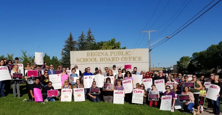Members picket outside school board meeting