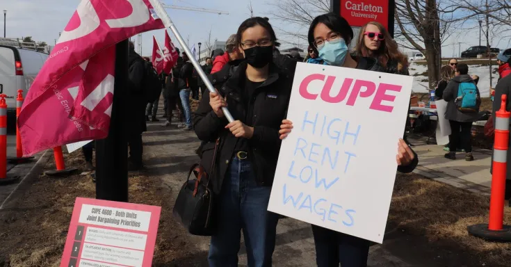 CUPE 4600 members with a picket sign saying High rent, low wages