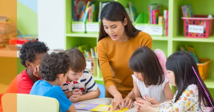 Teacher talking to kids in classroom