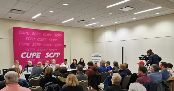 People sitting at a table for a press conference 