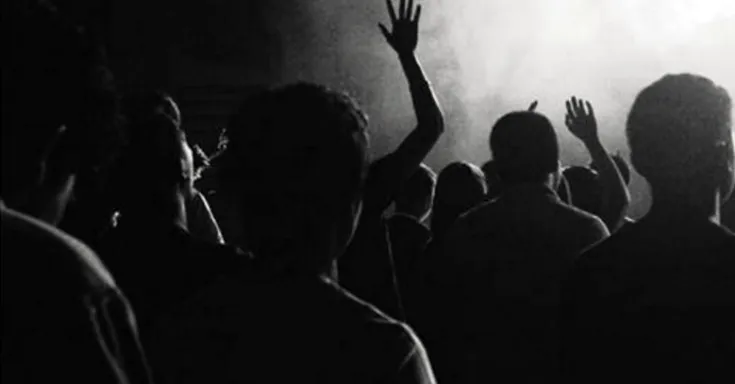 Black and white image of a crowd of people from the back
