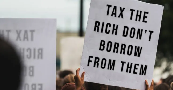 protest sign that reads Tax the Rich