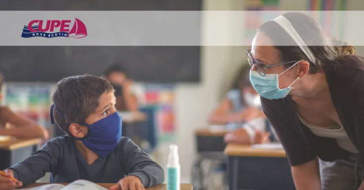 Web banner. Image: Teacher talking to young student at his desk. Both are wearing a face mask. CUPE NS logo.
