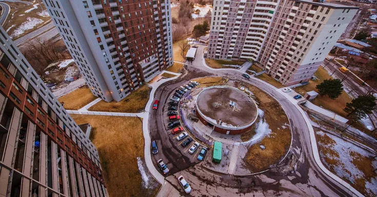 Three high rise apartment buildings and a circular driveway