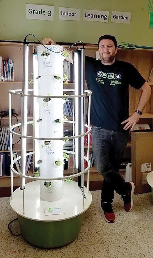Stefan Sommer with one of the hydroponic towers