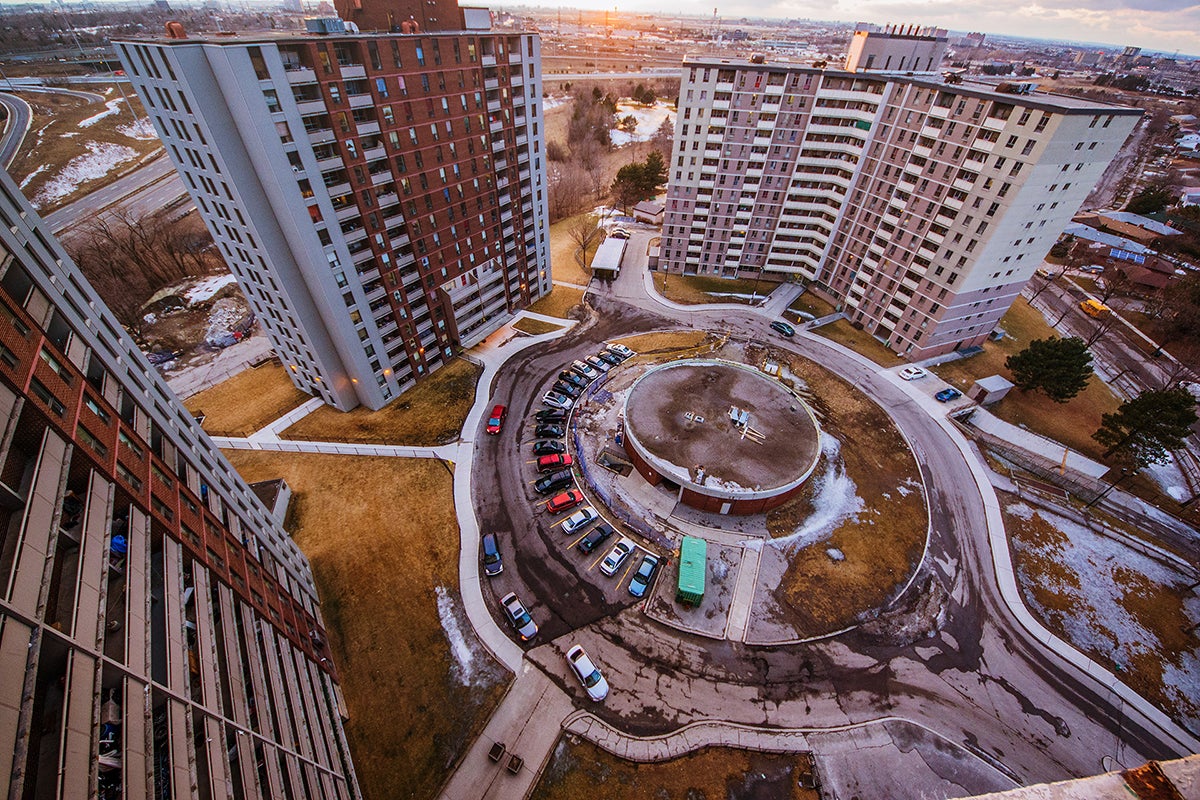 Three high rise apartment buildings and a circular driveway